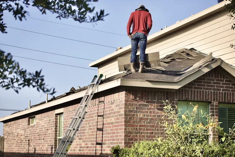 Professional roofer working on a residential roof in Brookeville Heights